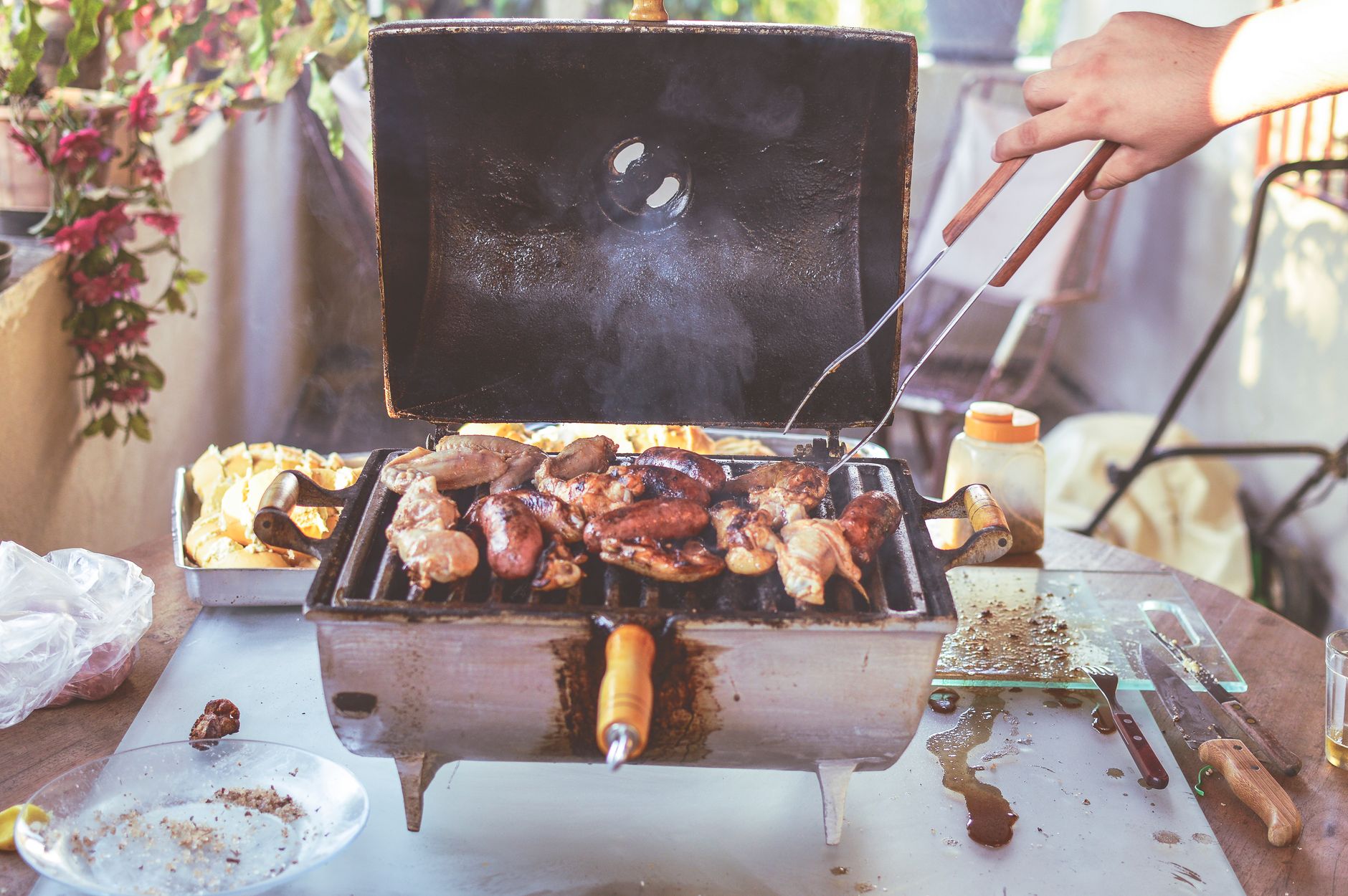 Person grilling at a built-in outdoor grill station