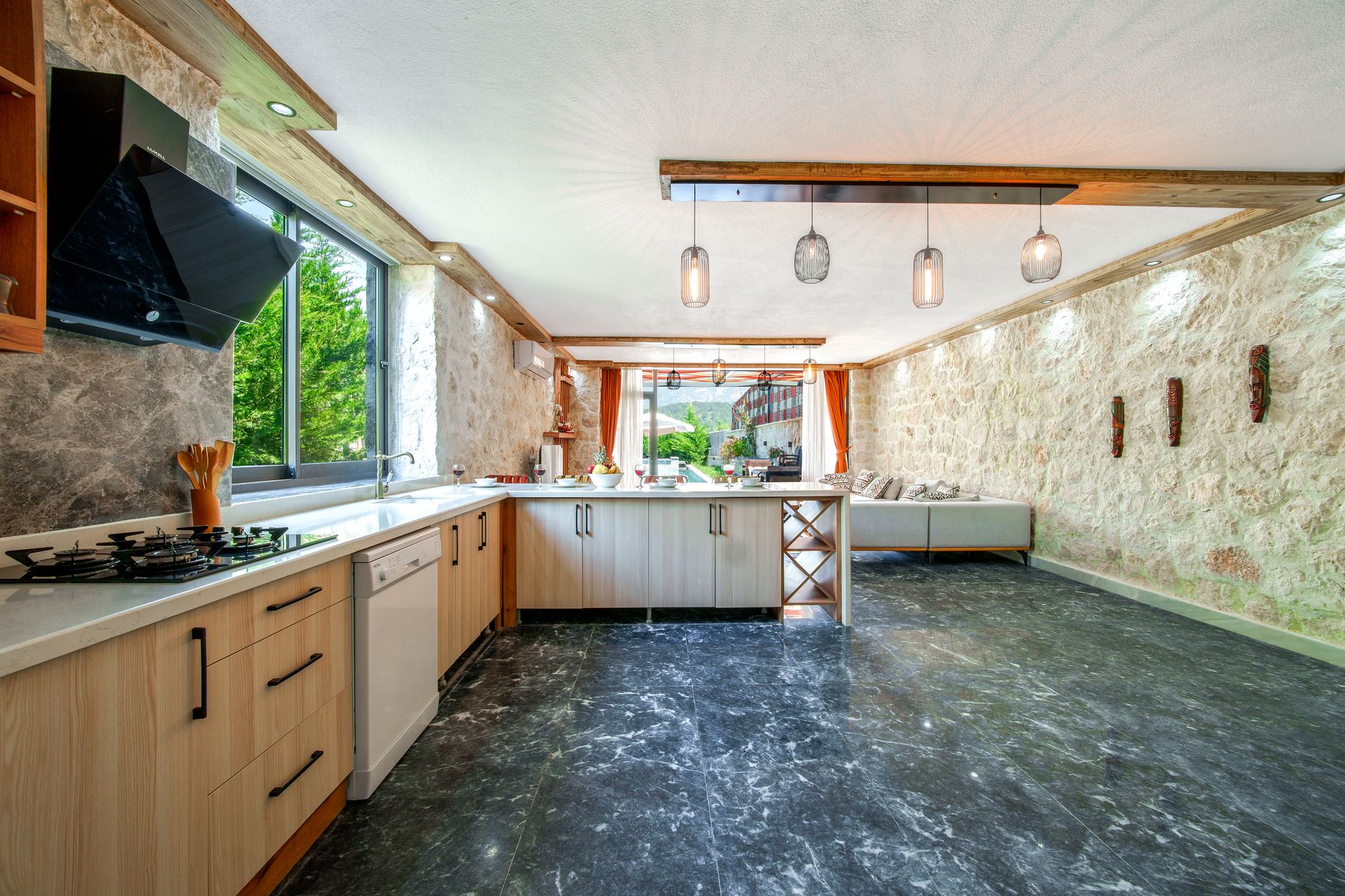 Custom stone outdoor kitchen island with built-in grill in a St. Louis backyard